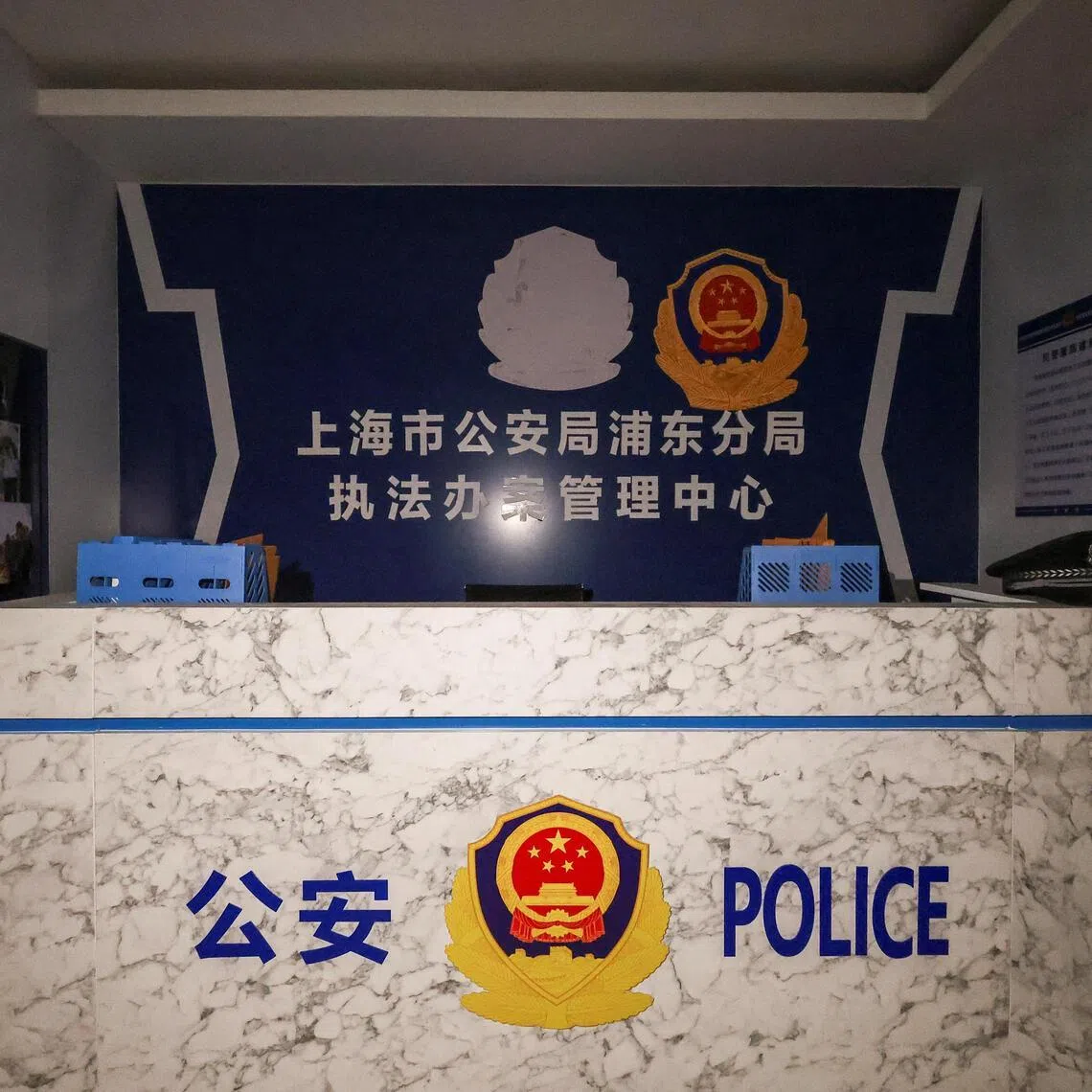 A room set up to imitate a China police station, inside a compound in O'Smach, Cambodia used for scam operations.
