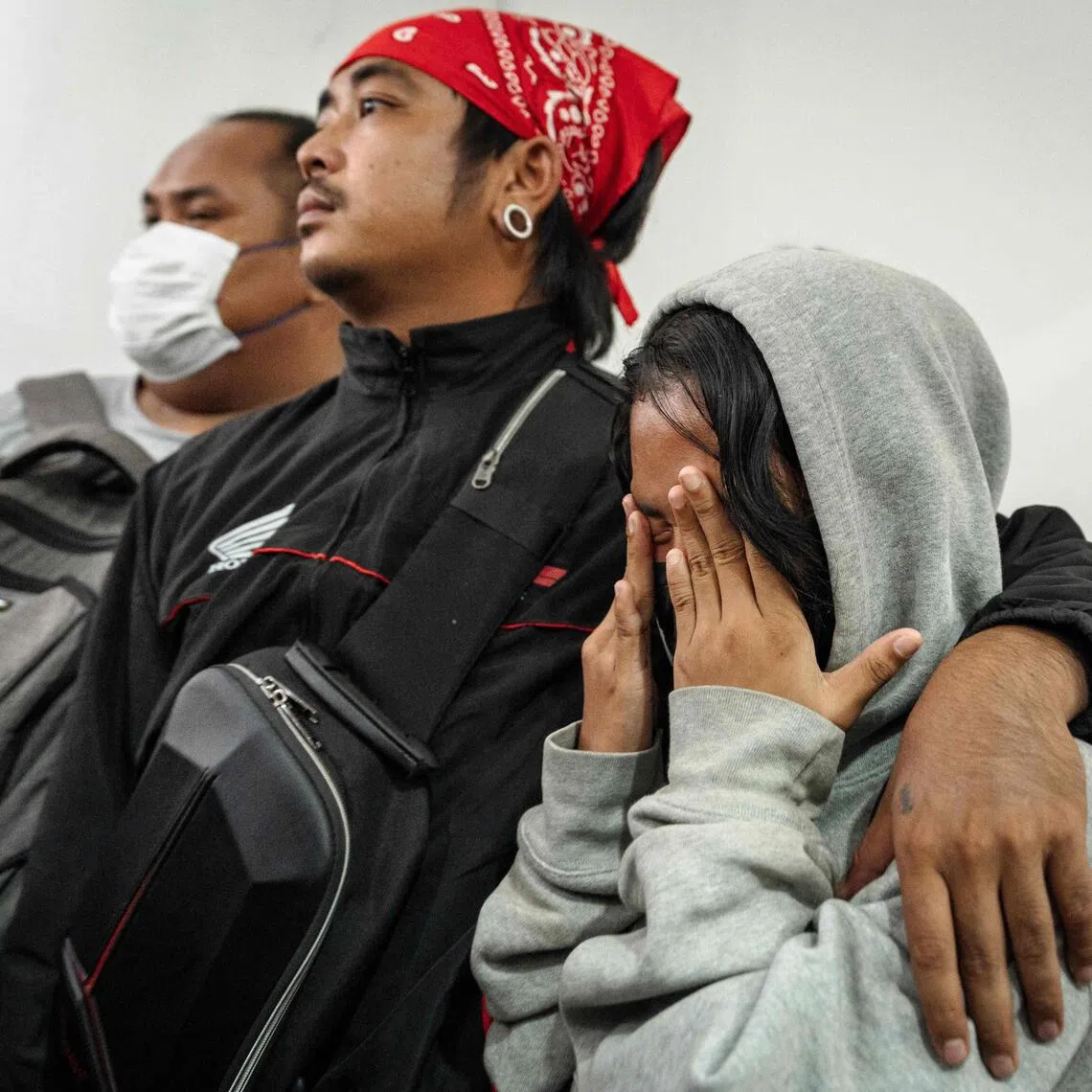 Relatives mourning victims killed in a bar fire at Police General Hospital in Bangkok in July.