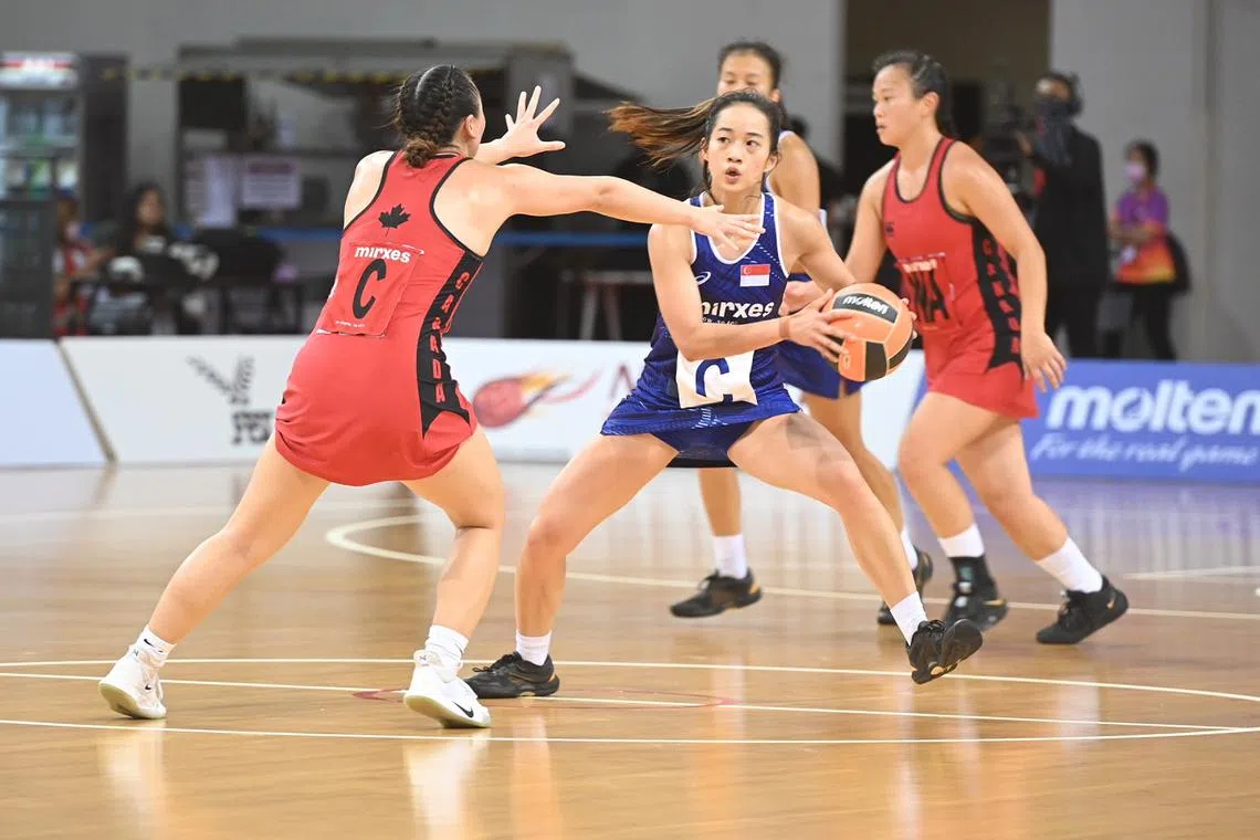 National netballer Tan Yi Jie (with ball) in action during Singapore's 46-40 win over Canada in the Mirxes Nations Cup.