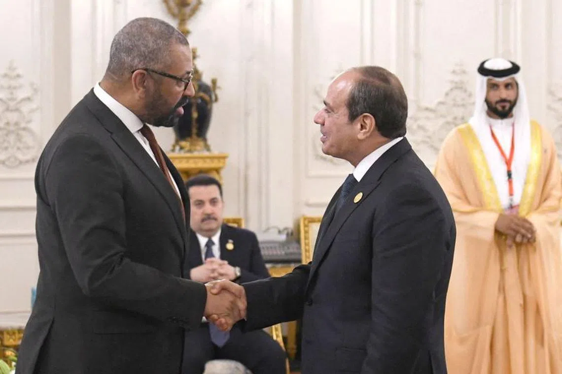Egyptian President Abdel Fattah al-Sisi greets British Foreign Secretary James Cleverly during the Cairo international summit for peace in the Middle East, in the New Administrative Capital (NAC), east of Cairo, Egypt, October 21, 2023 in this handout picture courtesy of the Egyptian Presidency. The Egyptian Presidency/Handout via REUTERS