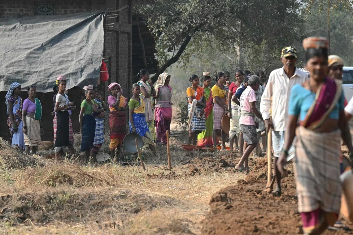This photograph taken on February 14, 2026 shows wage-labourers under Mahatma Gandhi National Rural Employment Guarantee Act (MGNREGA) waiting for their turn at a road-construction site at Balapur Dolkarpada village in Maharashtra's Palghar district. India's economy grew at a faster pace than expected in the last quarter of 2025 driven by solid consumer spending, data showed on February 27, using a new framework that calculates economic output more accurately.