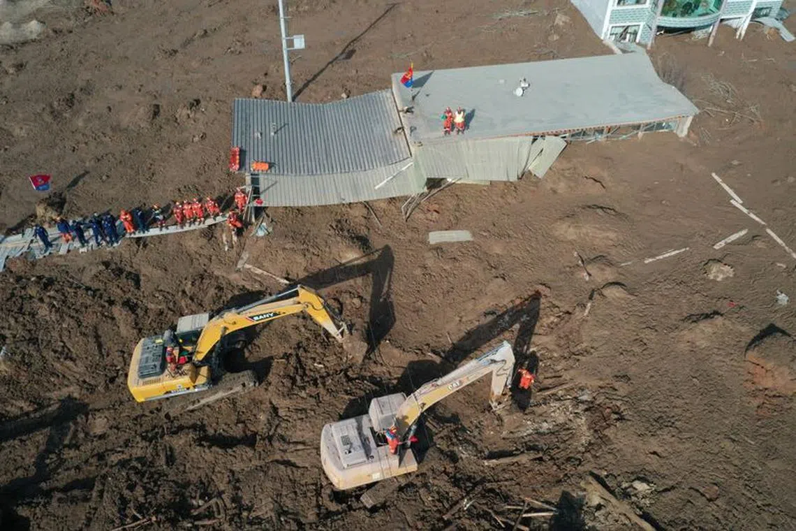 FILE PHOTO: An aerial view shows buildings covered in silt amid rescue operations after the earthquake in Gansu's Jishishan county triggered a mudslide in Jintian village, Qinghai province, China December 19, 2023. cnsphoto via REUTERS