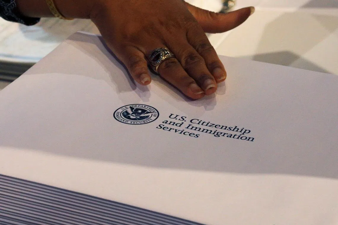 FILE PHOTO: Information packs are distributed by the U.S. Citizenship and Immigration Services following a citizenship ceremony at the John F. Kennedy Presidential Library in Boston, Massachusetts, U.S., July 18, 2018.   REUTERS/Brian Snyder/File Photo