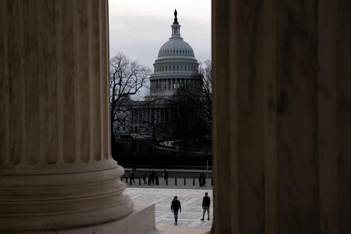 FILE PHOTO: Tourists walk near the U.S. Capitol as the Senate votes to begin work on a bill that includes aid for Ukraine, Israel and Taiwan in Washington, U.S., February 9, 2024. REUTERS/Nathan Howard/File Photo