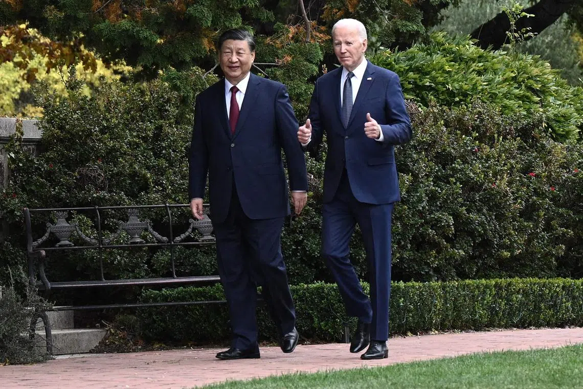 (FILES) US President Joe Biden (R) and Chinese President Xi Jinping walk together after a meeting during the Asia-Pacific Economic Cooperation (APEC) Leaders' week in Woodside, California on November 15, 2023. President Joe Biden and Xi Jinping spoke on the phone on April 2, 2024 in a new bid to manage tensions between the United States and China, with top US officials to head shortly to Beijing, officials said. (Photo by Brendan SMIALOWSKI / AFP)