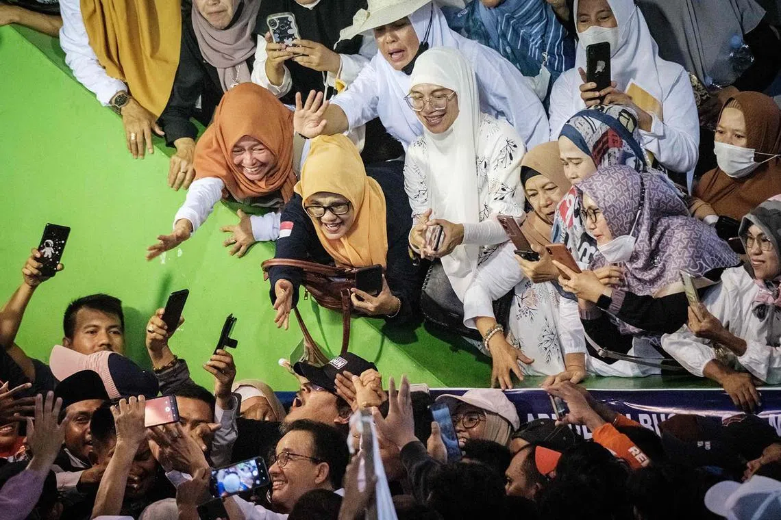 TOPSHOT - Presidential candidate Anies Baswedan's supporters react at his campaign rally in Serang on December 21, 2023. (Photo by Yasuyoshi CHIBA / AFP)
