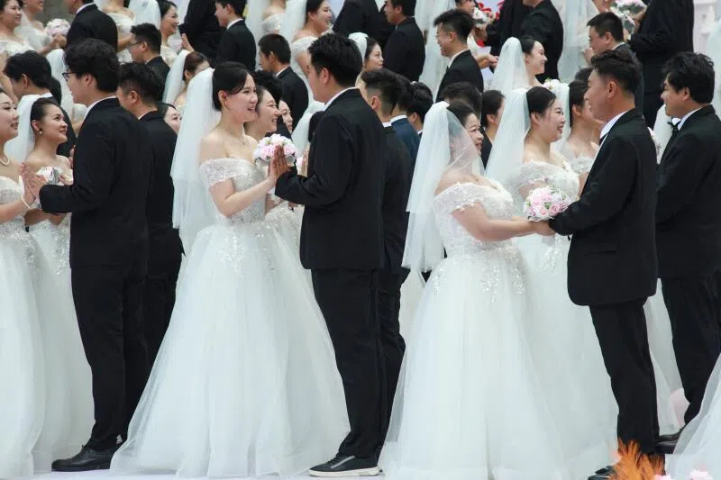 Couples at a collective wedding ceremony in Shenyang. In China’s cut-throat marriage market, cars, houses and savings are all topics for a first date. More offbeat is the number of siblings.