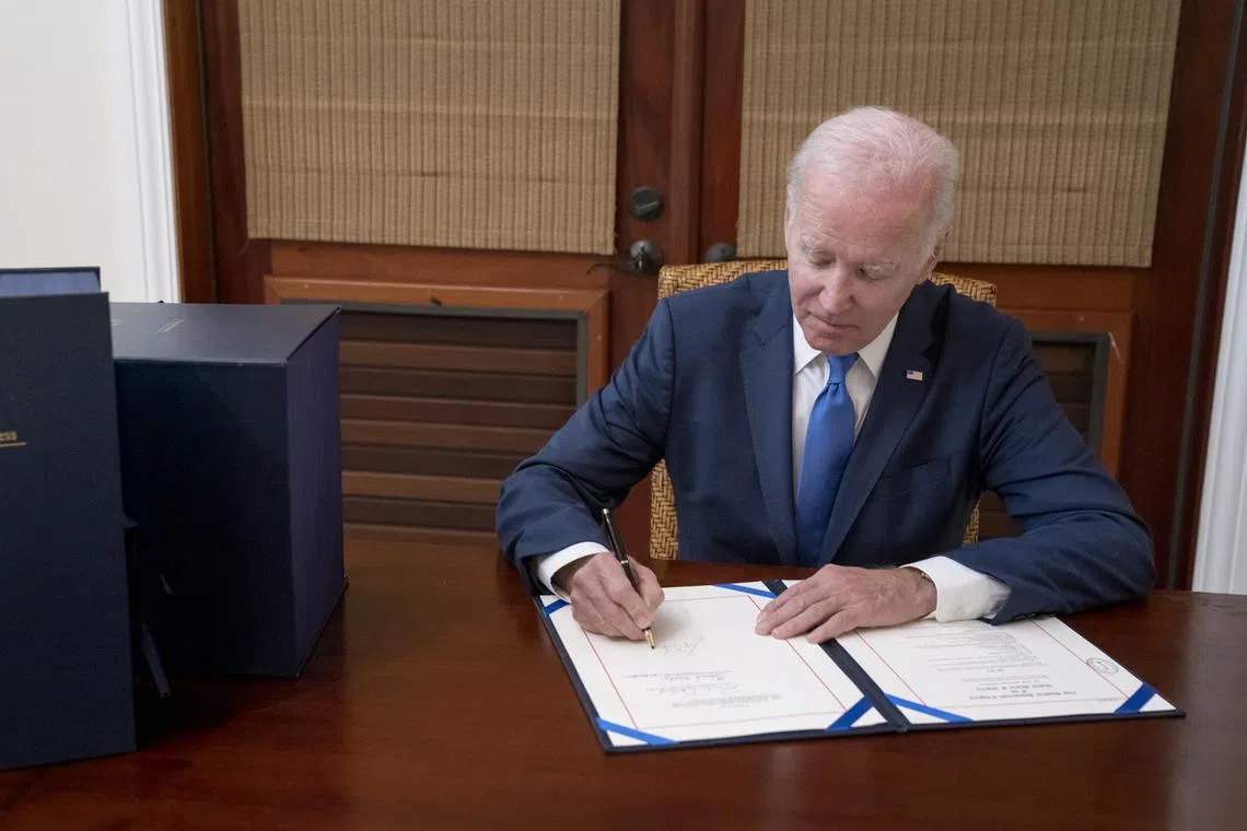 Mr Joe Biden tweeted a picture of himself signing the Bill into law.