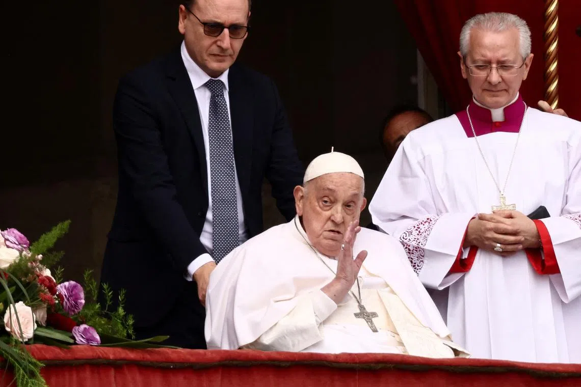 Pope Francis greets thousands of Catholics from the main balcony of St. Peter's basilica on April 20.