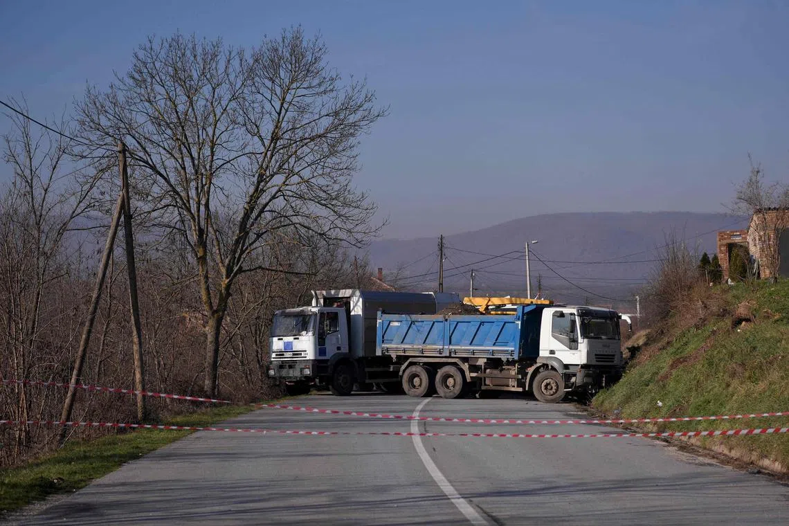 Trucks being used by Serbs to barricade a road in the village of Rudare near the town of Zvecan, on Dec 26, 2022.