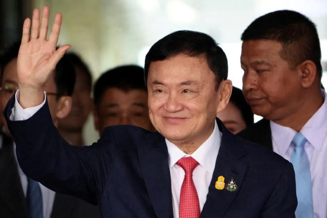 FILE PHOTO: Former Thai Prime Minister Thaksin Shinawatra, who is expected to be arrested upon his return as he ends almost two decades of self-imposed exile, waves at Don Mueang airport in Bangkok, Thailand August 22, 2023. REUTERS/Athit Perawongmetha/File Photo