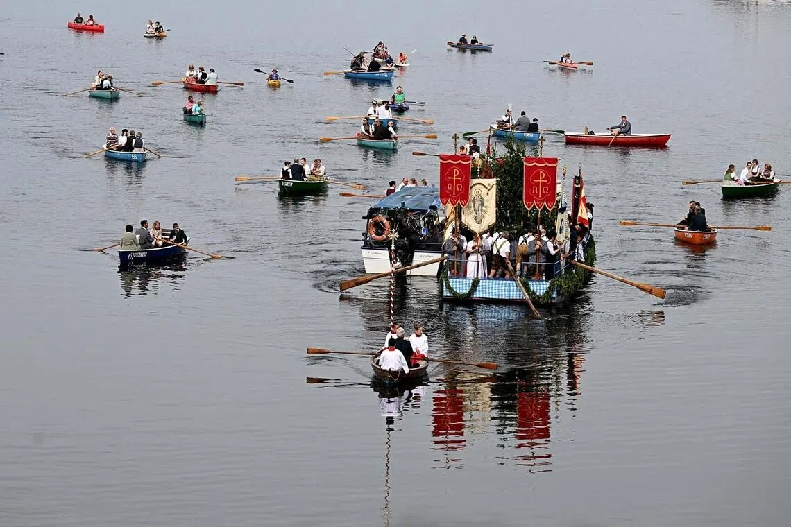 Catholics taking part in the traditional Bavarian Corpus Christi boat procession on Lake Staffelsee in Germany, June 4.