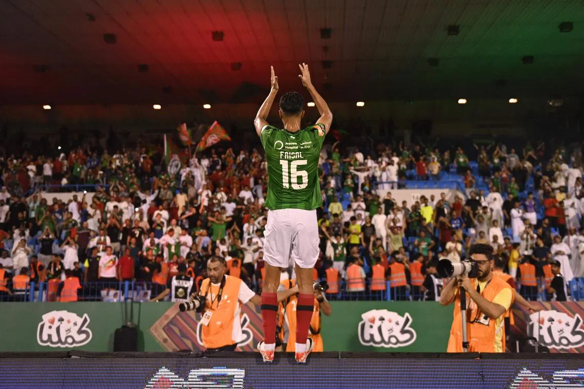 Ettifaq's Saudi midfielder #16 Faisal al-Ghamdi celebrates with the fans after their win in the Saudi Pro League football match between Al-Ettifaq and Al-Nassr at the Prince Mohamed bin Fahd Stadium in Dammam on August 14, 2023. (Photo by Ali Alhaji / AFP)