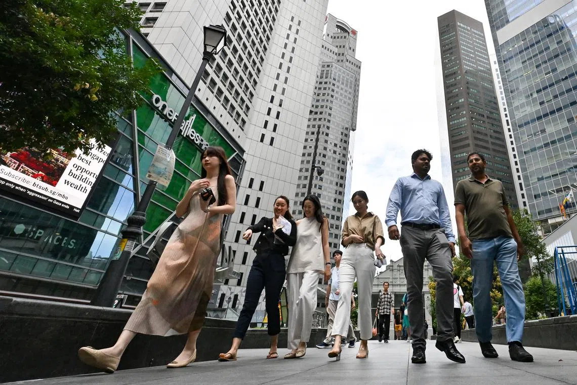 Office workers walking at Raffles Place Park within the heart of Singapore's financial centre in the CBD area on Feb 14, 2024. employment, manpower, labour