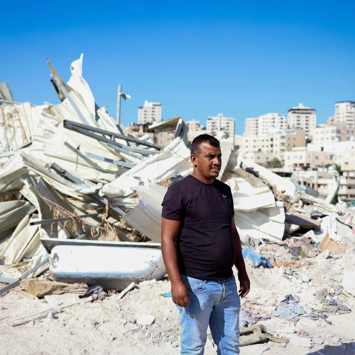 Palestinian Yahya Abu Ghaliyeh in front of his demolished home in Al-Eizariya town near Jerusalem on Sept 30.