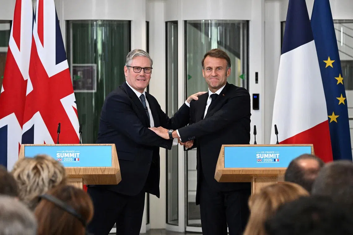 FILE PHOTO: British Prime Minister Keir Starmer (L) and French President Emmanuel Macron shake hands as they hold a press conference on July 10, 2025 in London, England. Leon Neal/Pool via REUTERS/File Photo