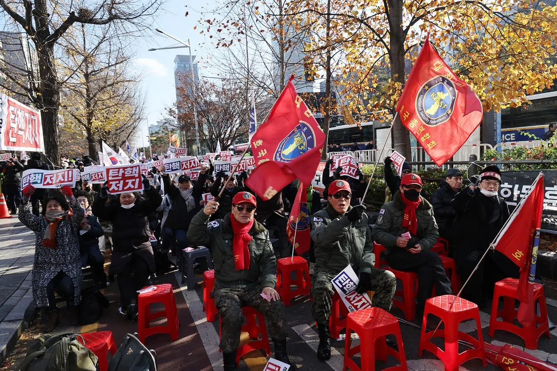 epa11761815 Members of the Korea National Security Federation sing as they attend a rally held in support of President Yoon Suk Yeol in Seoul, South Korea, 07 December 2024. Yoon faces an impeachment motion from opposition lawmakers after he declared and then reversed martial law, citing the need to root out pro-North Korean forces and uphold the constitutional order. EPA-EFE/HAN MYUNG-GU