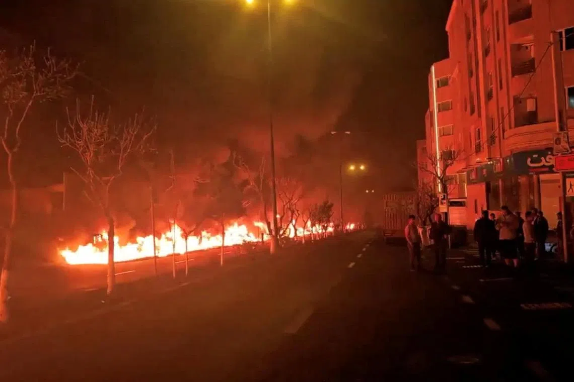 Fire burns along Tehran's Koohsar Boulevard in this screengrab from a video on social media released on March 8. Israeli strikes on Tehran oil infrastructure in March produced toxic fumes.