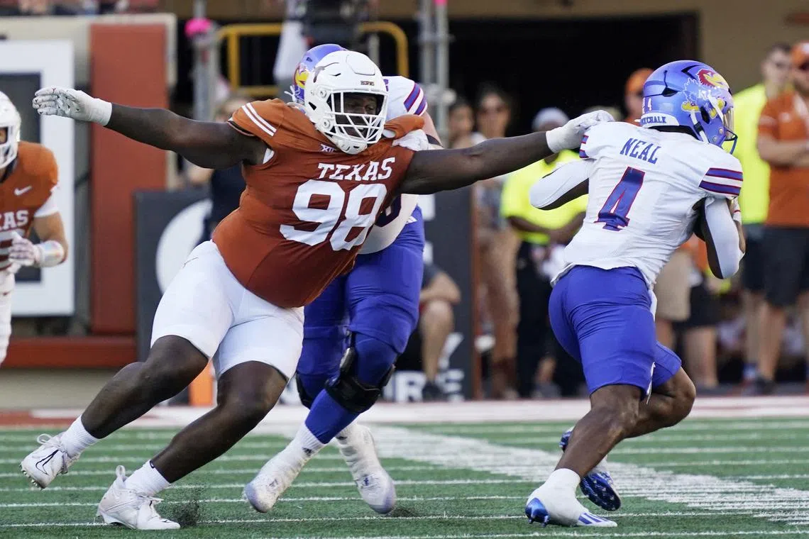 Sep 30, 2023; Austin, Texas, USA; Texas Longhorns defensive lineman Trill Carter (98) reaches for Kansas Jayhawks running back Devin Neal (4) during the second half at Darrell K Royal-Texas Memorial Stadium. Mandatory Credit: Scott Wachter-USA TODAY Sports/ File Photo