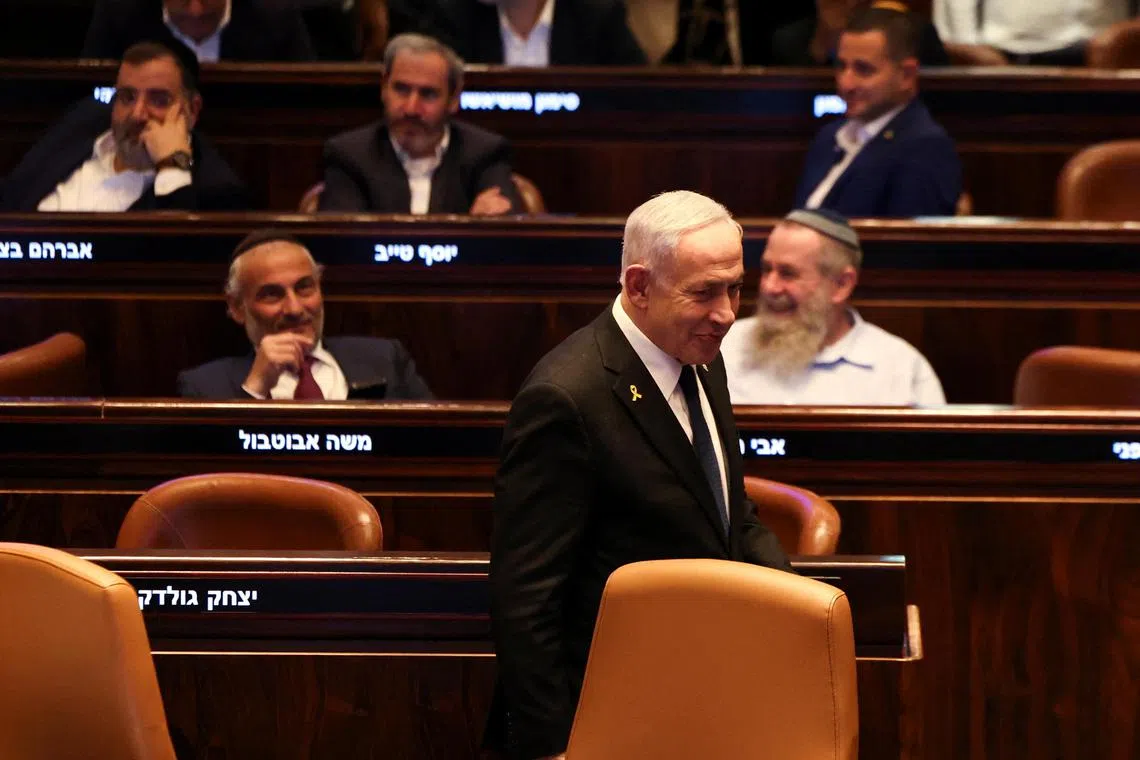 Israeli Prime Minister Benjamin Netanyahu walks in the Knesset, Israel's parliament, on the day of a vote over a possible expulsion of Ayman Odeh from parliament, in Jerusalem, July 14, 2025. REUTERS/Ronen Zvulun