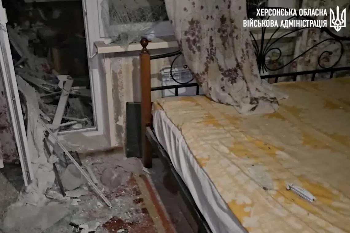 Debris is scattered inside an apartment after shelling in a residential block in Kherson, Ukraine, in this screengrab taken from a video released on Dec 3, 2023.   