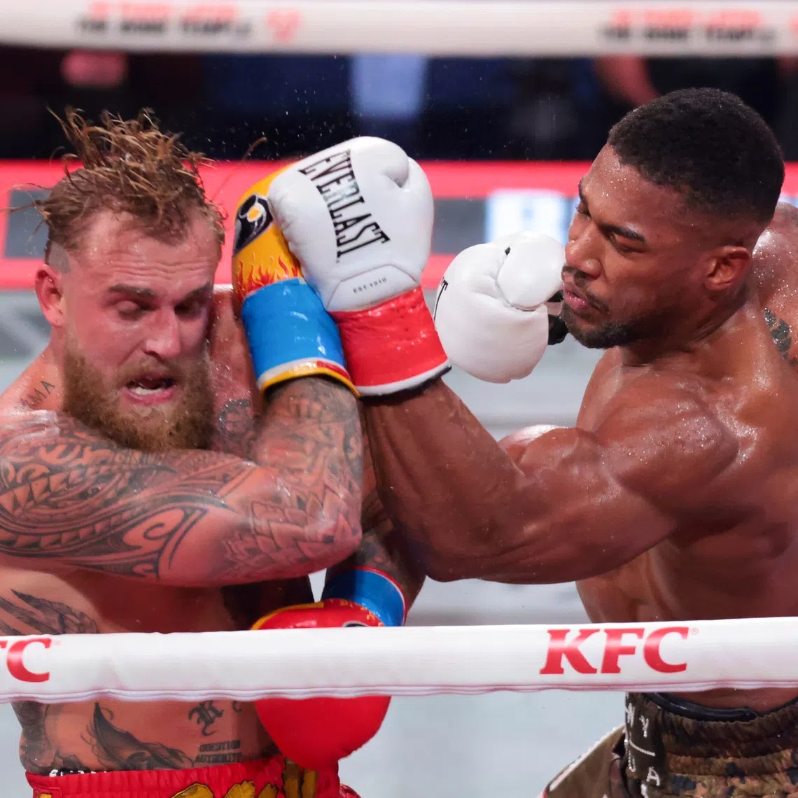 Dec 19, 2025; Miami, Florida, UNITED STATES; Anthony Joshua hits Jake Paul during a heavyweight boxing bout at Kayesa Center. Mandatory Credit: Sam Navarro-Imagn Images