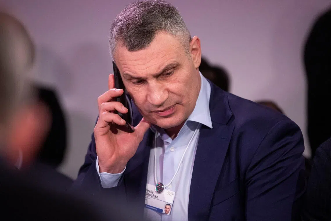 Mayor of Kyiv Vitali Klitschko uses a mobile phone ahead of a "Special Dialogue with CEO's" meeting at the World Economic Forum (WEF) in Davos, Switzerland, on Jan 18, 2023. 