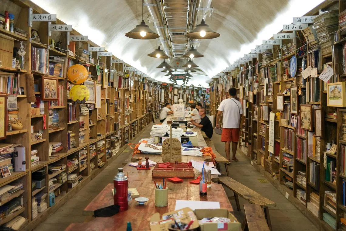 awletter - Patrons at a bunker-turned-bookshop in Chongqing in south-western China. Books there are mainly about Chongqing's history and categorised based on the municipality's districts.

Copyright: Aw Cheng Wei
