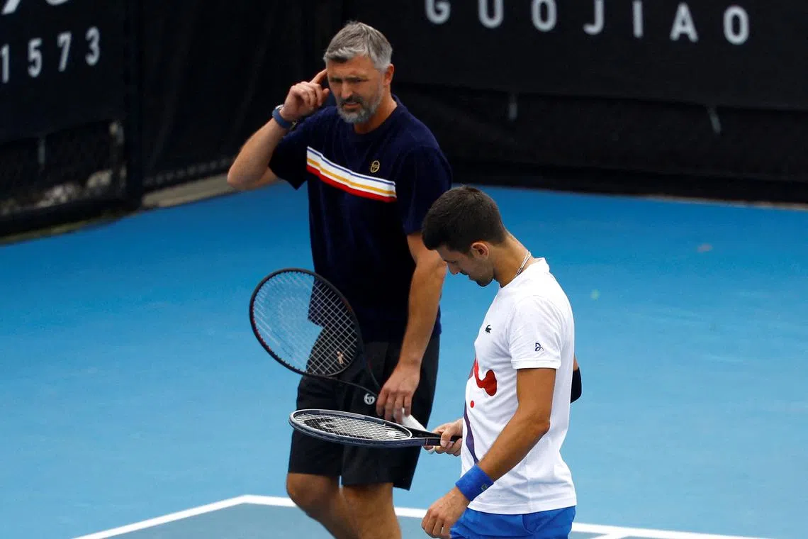 FILE PHOTO: Tennis - Australian Open - Melbourne Park, Melbourne, Australia - January 20, 2024 Serbia's Novak Djokovic and his coach Goran Ivanisevic react during a practice session REUTERS/Issei Kato/File Photo