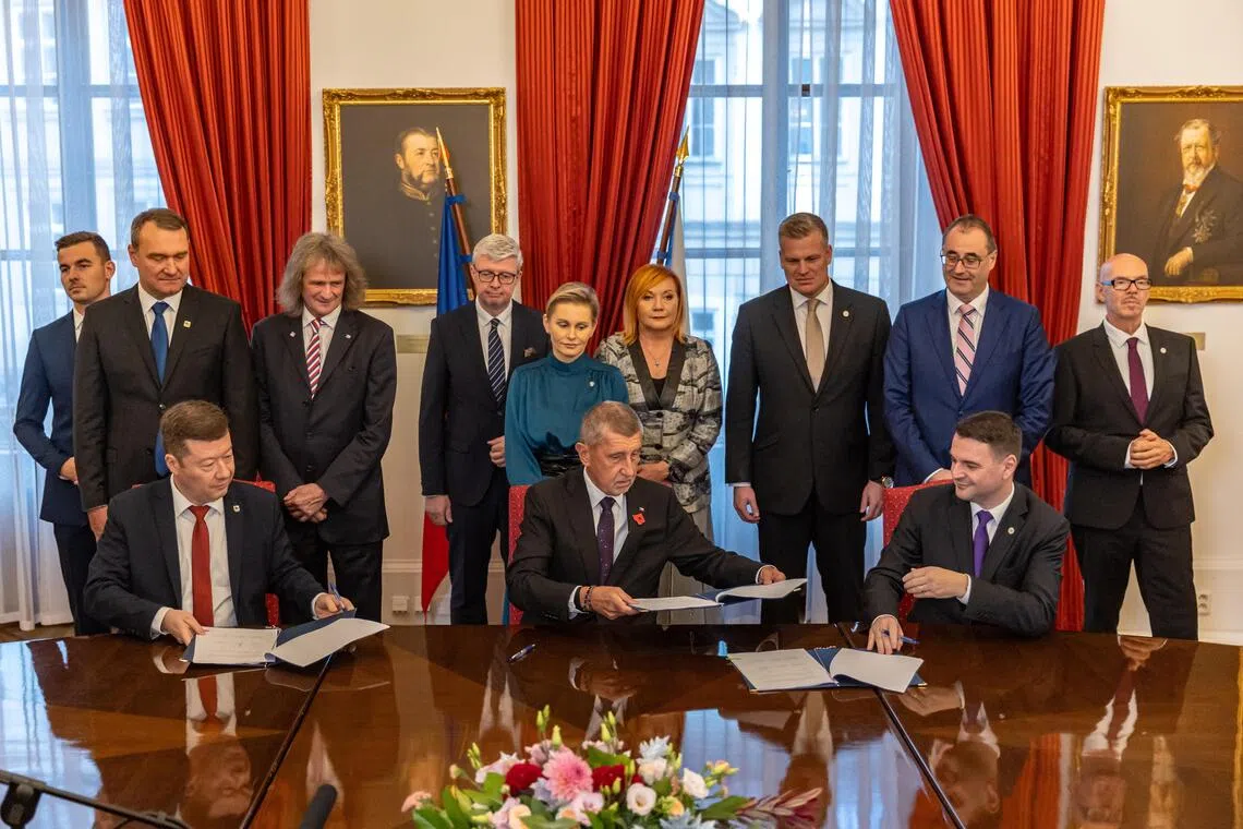 Czech billionaire and ANO party leader Andrej Babis (seated, centre) has joined forces with the Motorists party, which is sceptical about climate change, and the SPD party, which is against the EU and Nato.