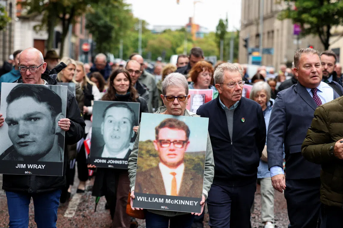 FILE PHOTO: Families of the victims of the 1972 'Bloody Sunday' killings walk to the high court on the first day of the trial of the British army veteran known as 'Soldier F' charged with two murders and five attempted murders in relation to Bloody Sunday, in Belfast, Northern Ireland, September 15, 2025. REUTERS/Cathal McNaughton/ File Photo