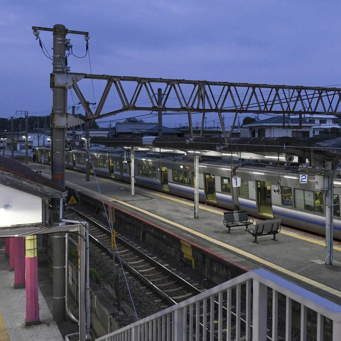 The first morning train leaving Hatsushima station after the new building, made from 3D-printed components, was assembled in Arida, Japan, on March 26, 2025. Construction started after the night’s last train departed and was finished before the first train arrived in the morning. (Noriko Hayashi/The New York Times)