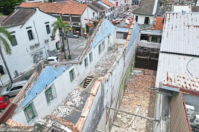 An aerial view showing pre-war houses demolished at Lebuh China in George Town, Penang, leaving only skeletal structures behind. 