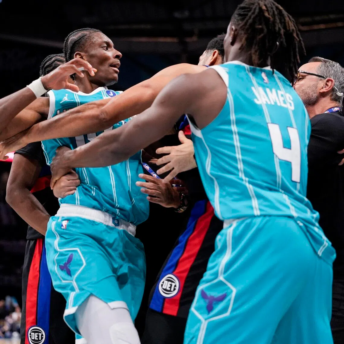 Charlotte Hornets forward Moussa Diabate being held back by guard Sion James from engaging with Detroit Pistons forward Tobias Harris during the second half of Detroit's 110-104 NBA win at Spectrum Center on Feb 9. Four players were ejected after the third-quarter melee.