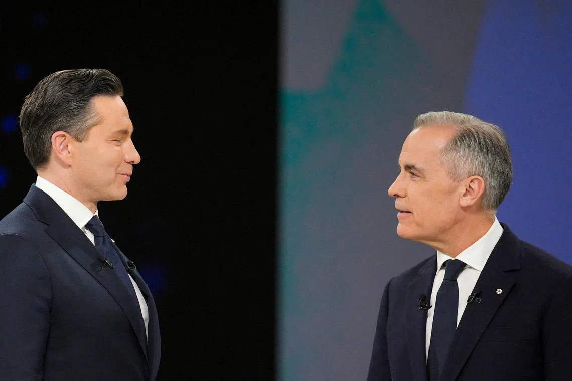 FILE PHOTO: Conservative Leader Pierre Poilievre and Liberal Leader Mark Carney talk following the English-language federal leaders' debate in Montreal, Canada, Thursday, April 17, 2025. Christopher Katsarov/Pool via REUTERS/File Photo