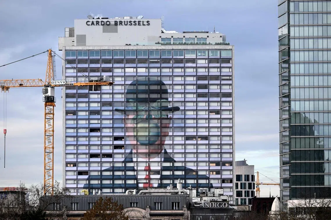 A reproduction of the painting The Son of Man by Belgian surrealist painter Rene Magritte is reproduced on the facade of a hotel in Brussels, Belgium on Feb 4, 2026. 