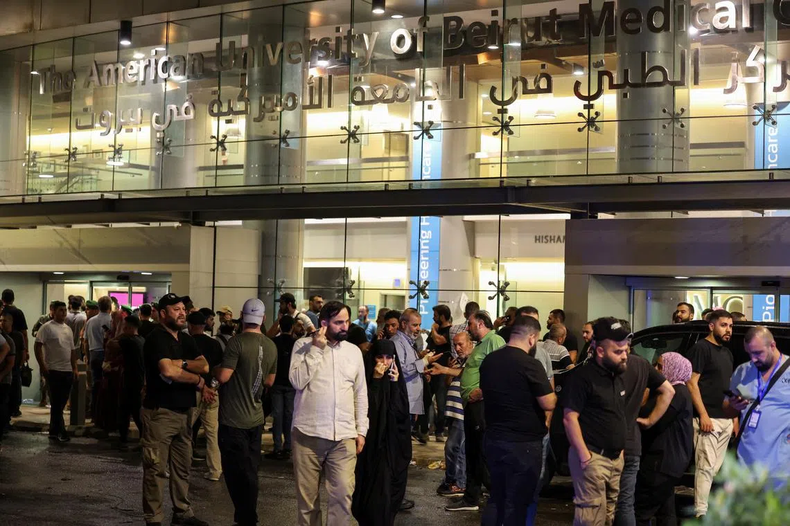 FILE PHOTO: People gather outside American University of Beirut Medical Center (AUBMC) as people, including Hezbollah fighters and medics, were wounded when the pagers they use to communicate exploded across Lebanon, according to a security source, in Beirut, Lebanon September 17, 2024. REUTERS/Mohamed Azakir/File Photo
