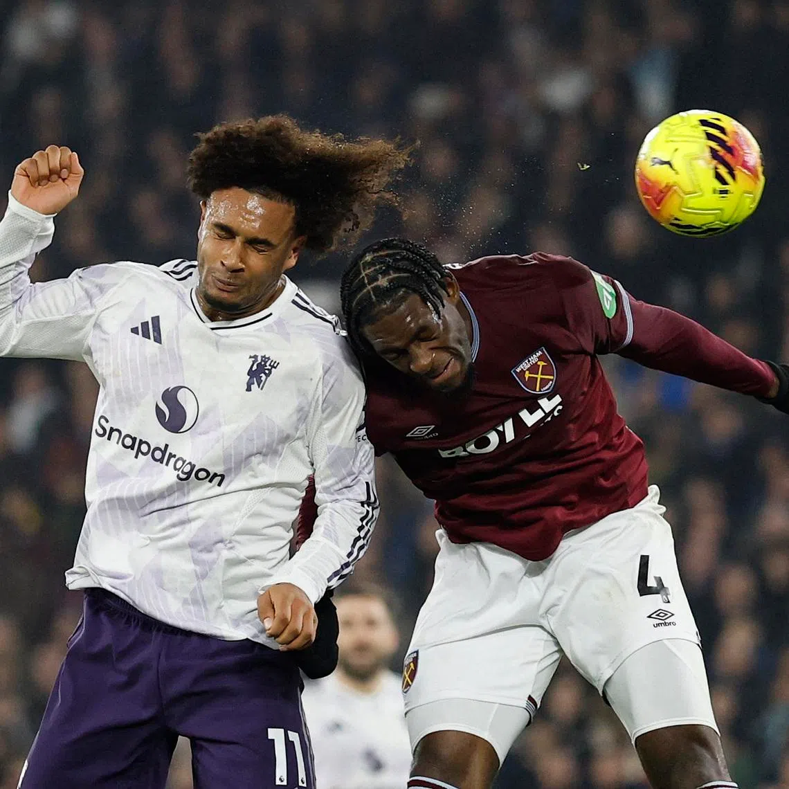 Soccer Football - Premier League - West Ham United v Manchester United - London Stadium, London, Britain - February 10, 2026 Manchester United's Joshua Zirkzee heads wide as West Ham United's Axel Disasi challenges Action Images via Reuters/Peter Cziborra