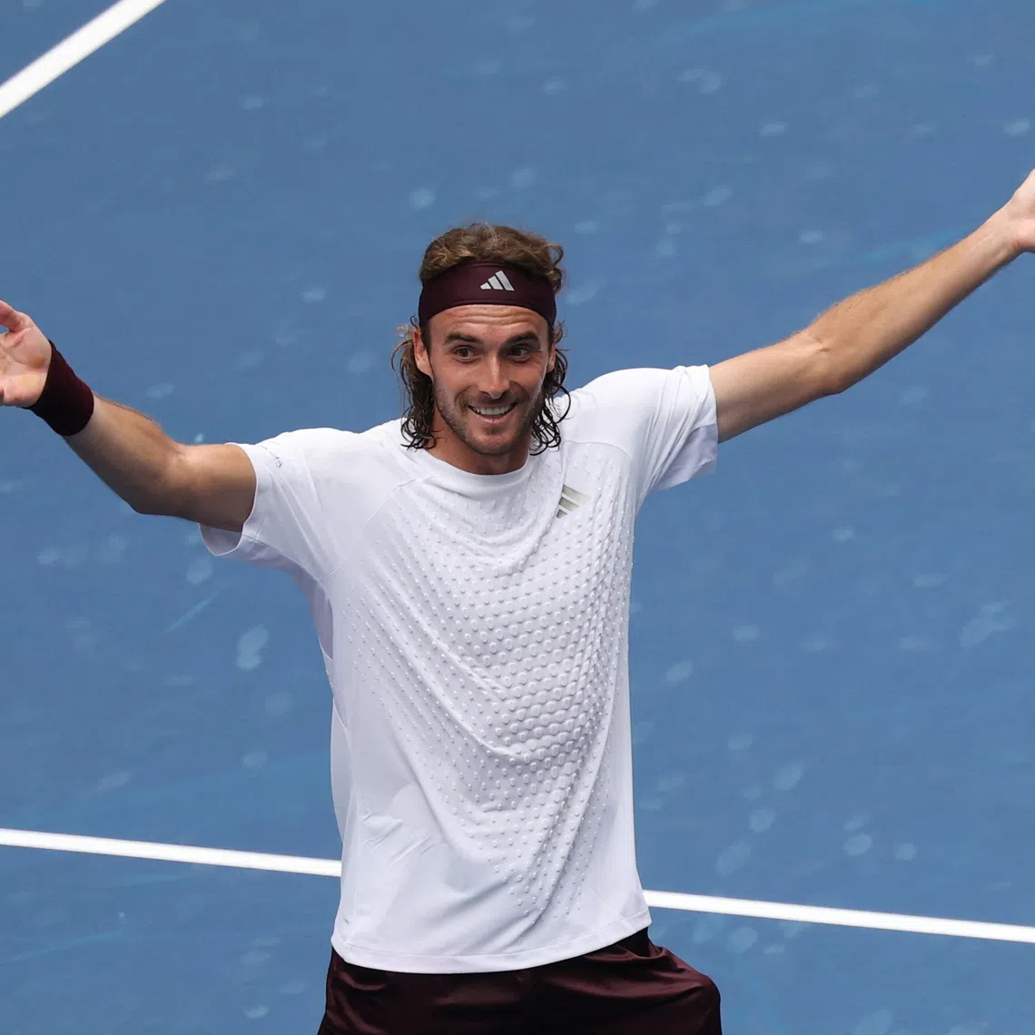 Stefanos Tsitsipas celebrates after winning his first round match against Arthur Fils.