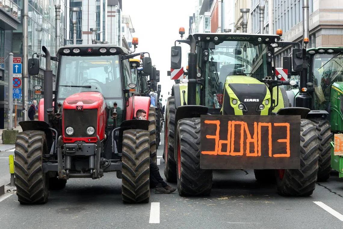 FILE PHOTO: Tractors stand on a street during a protest by Belgian farmers over price pressures, taxes and green regulation, on the day of an EU agriculture ministers' meeting in Brussels, Belgium March 26, 2024. REUTERS/Yves Herman/File Photo