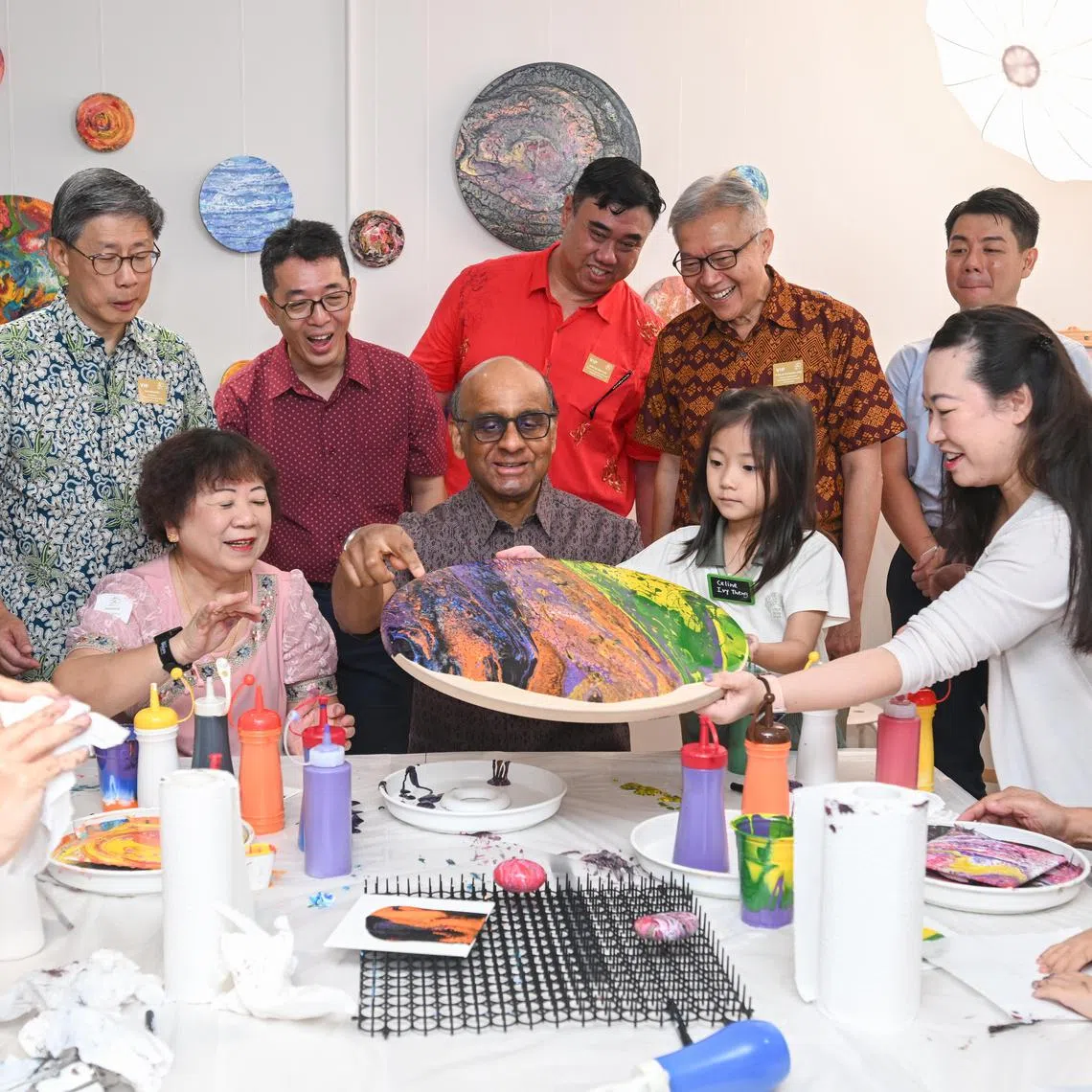President Tharman Shanmugaratnam participating in an acrylic art pouring session at A Good Place at One Holland Village on Feb 11.