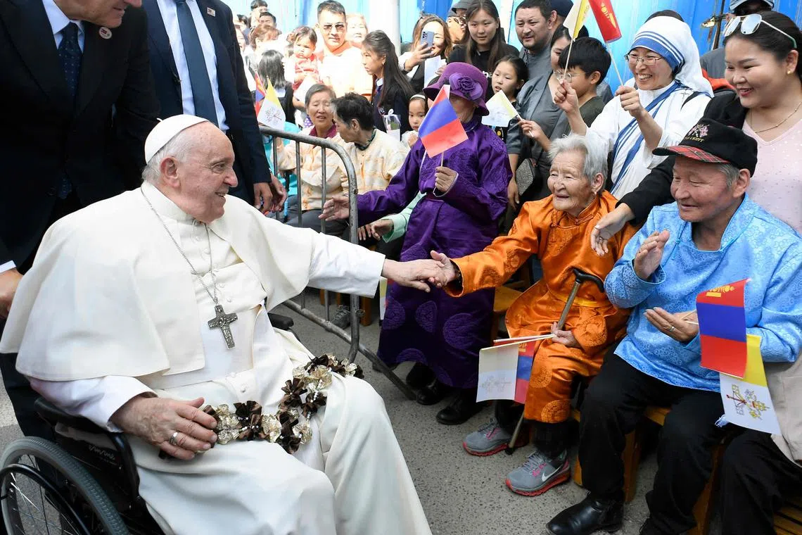 Catholic devotees greet Pope Francis upon his arrival at the Apostolic Prefecture of Ulaanbaatar, in Mongolia.