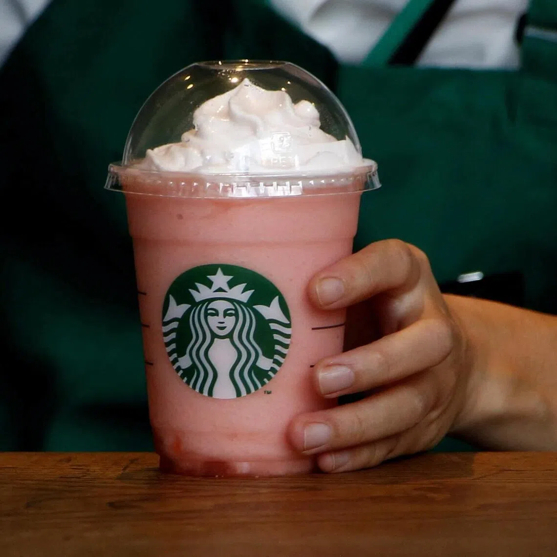 A waitress prepares a beverage at a branch of Starbucks coffee in Tokyo, Japan.