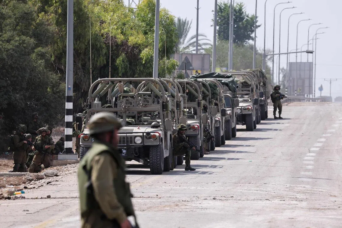 Israeli soldiers taking up position in Kfar Aza, bordering the Gaza Strip, on Oct 10.