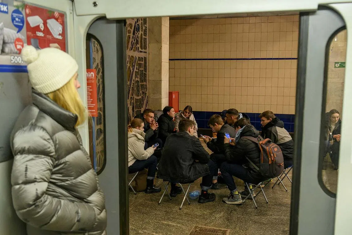 People taking shelter inside a metro station during a Russian missile strike, amid Russia's attack on Ukraine, in Kyiv, Ukraine, Dec 14, 2023. 