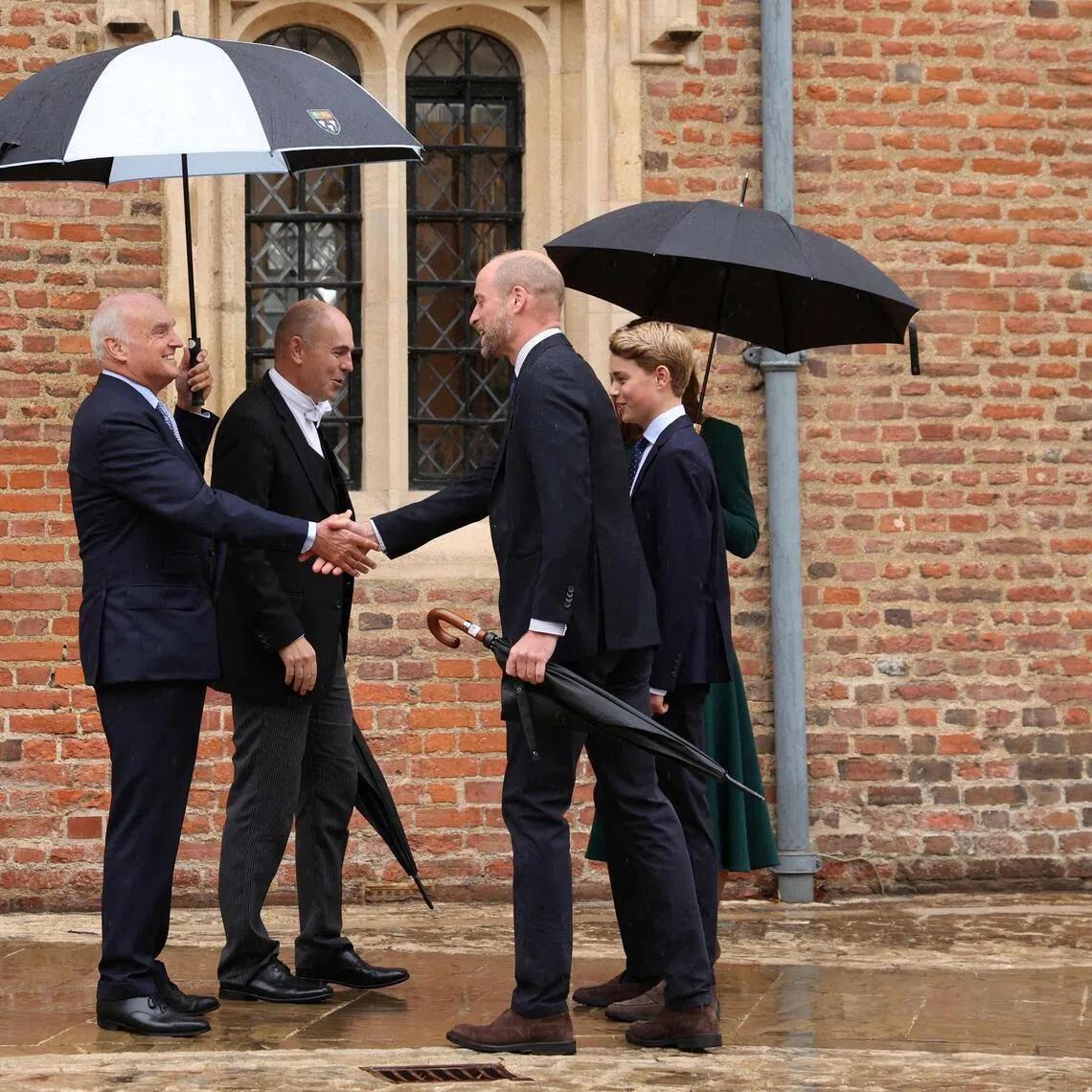 (From left) Eton College provost Nicholas Coleridge and headmaster Simon Henderson welcoming Britain’s Prince William and Catherine, Princess of Wales (hidden) as their 13-year-old son Prince George arrives for his first day on Sept 8.
