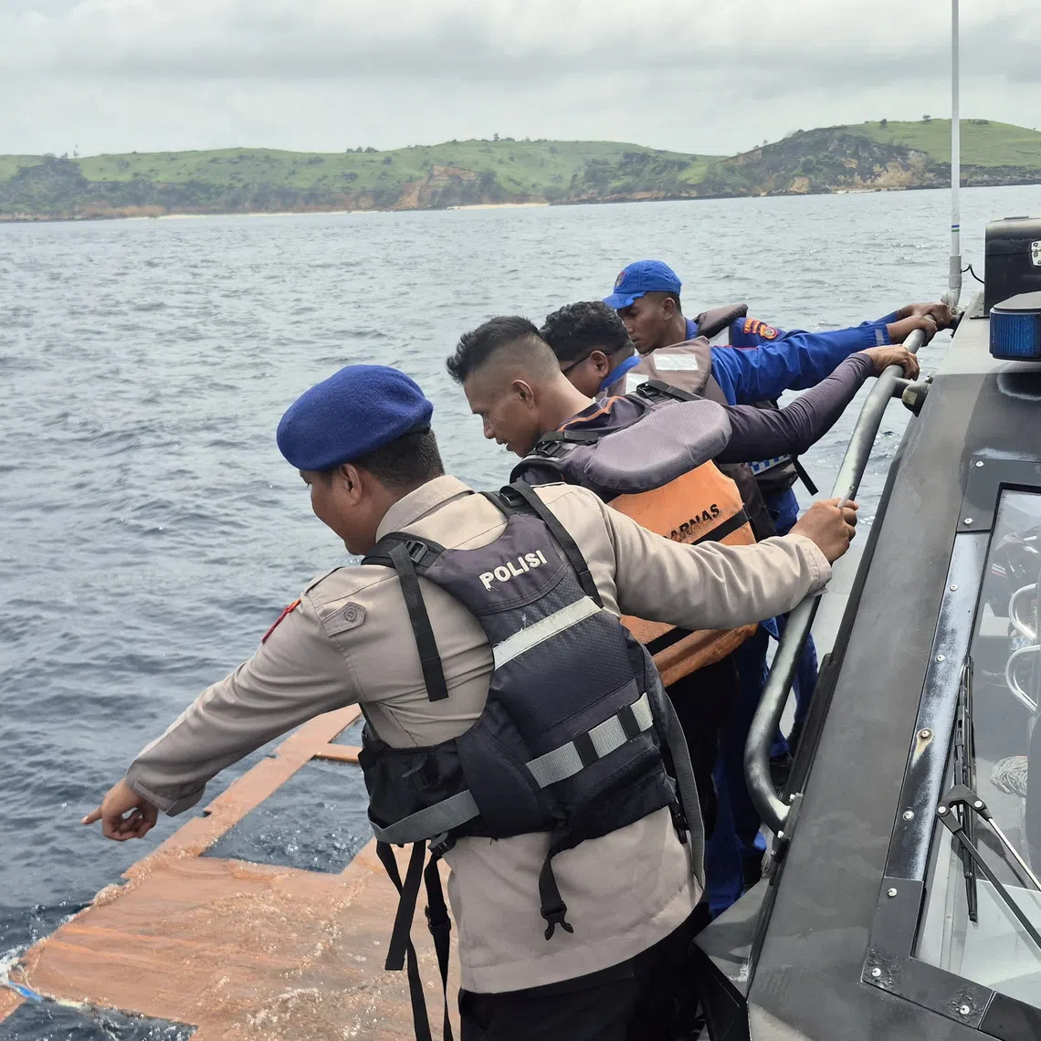 Rescue team members search for passengers missing since Friday night after a boat carrying several people sank off the coast of Indonesia in extreme weather, in the Padar Island Strait, Labuan Bajo, East Nusa Tenggara province, Indonesia, December 27, 2025, in this photo taken by Indonesia's National Search and Rescue Agency (BASARNAS)/Handout via REUTERS
