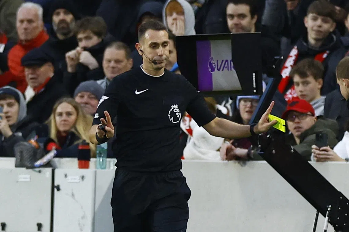 FILE PHOTO: Soccer Football - Premier League - Brentford v Aston Villa - Brentford Community Stadium, London, Britain - December 17, 2023 Referee David Coote shows a red card to Brentford's Ben Mee after checking the VAR monitor Action Images via Reuters/Peter Cziborra