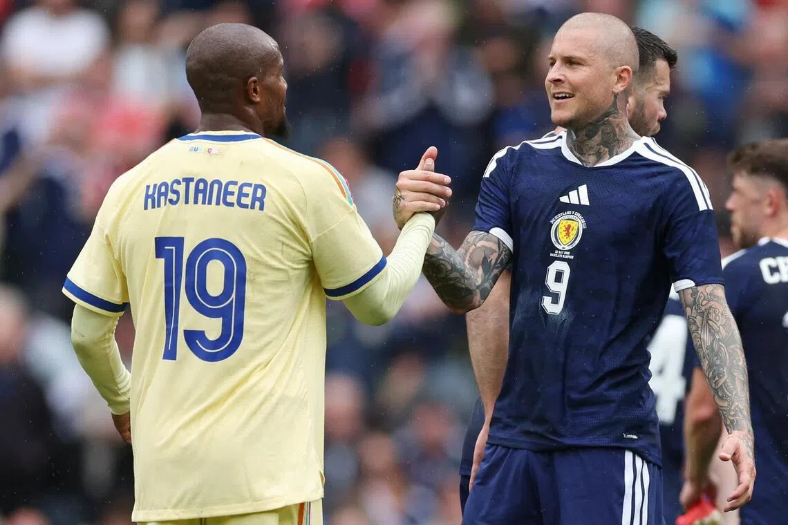 Curacao’s Gervane Kastaneer shaking hands with Scotland’s Lyndon Dykes after a friendly match on May 30.