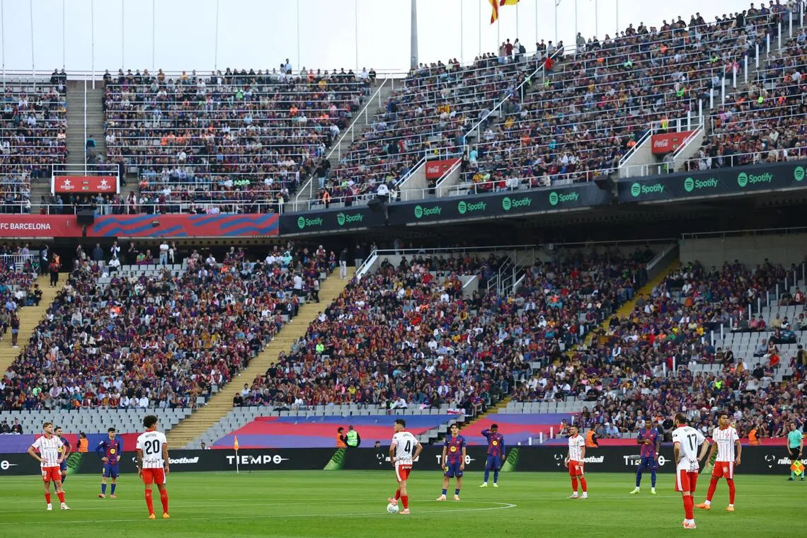 Barcelona and Girona players protesting at kick-off at the  Estadi Olimpic Lluis Company on Oct 18, 2025, due to La Liga's planned relocation of the Villarreal-Barcelona match to Miami. La Liga scrapped the plan on Oct 21.